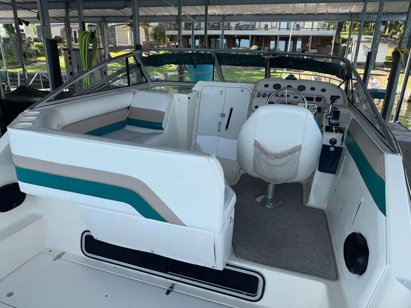 Slide: The Image of 1996 Rinker 280 Fiesta Vee boat interior with white seating and control panel. - 14