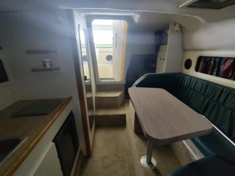 Slide: The Image of Interior of 1996 Rinker 280 Fiesta Vee boat with seating and table. - 18