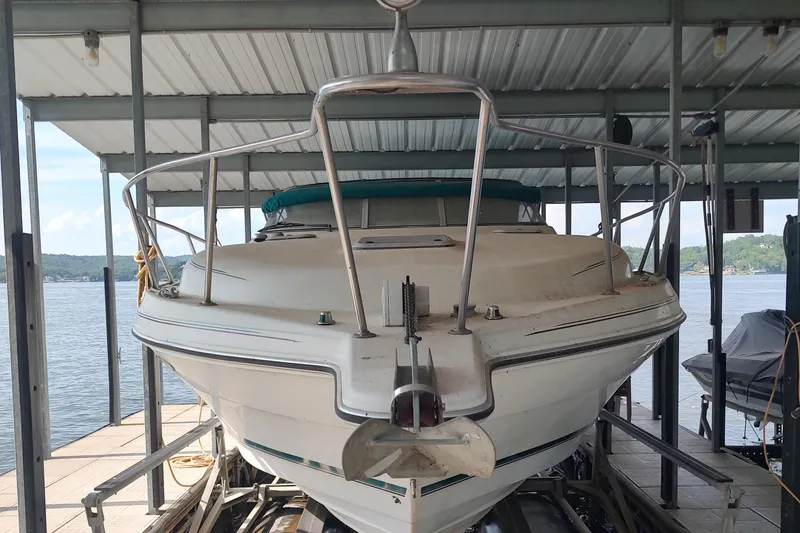 Slide: The Image of 1996 Rinker 280 Fiesta Vee boat docked under a metal canopy. - 20
