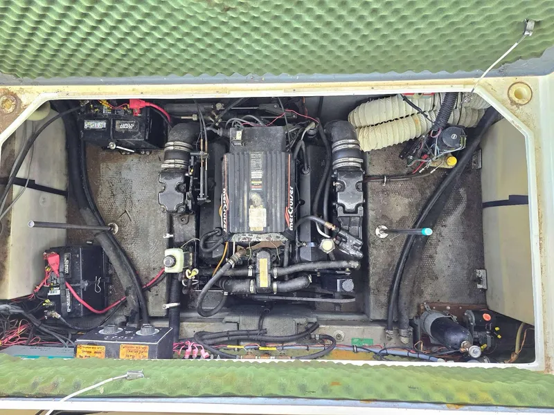 Slide: The Image of Engine compartment of a 1996 Rinker 280 Fiesta Vee boat, showing mechanical components. - 5
