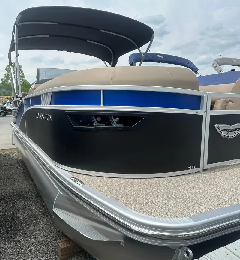 Slide: The Image of 2025 Bennington 23 LXSFB pontoon boat with sleek design and canopy. - 3