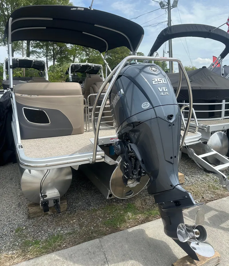 Slide: The Image of 2025 Bennington 23 LXSFB pontoon boat with Yamaha 250 V6 engine, docked outdoors. - 5