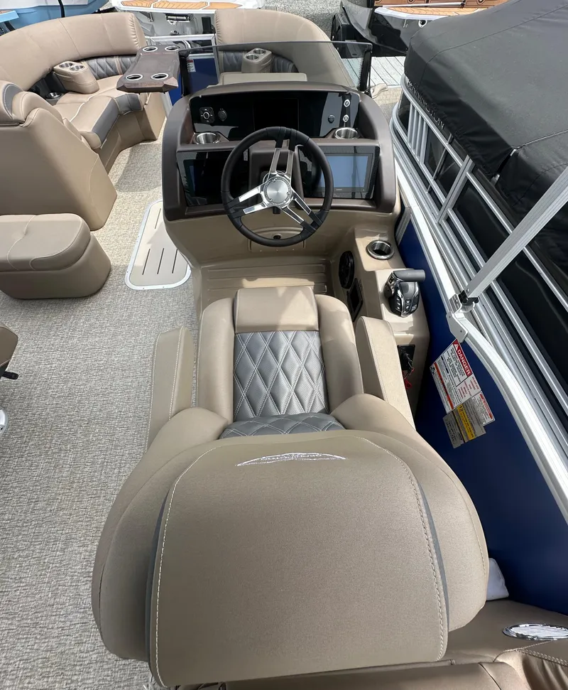 Slide: The Image of 2025 Bennington 23 LXSFB boat interior with luxurious seating and modern steering console. - 8
