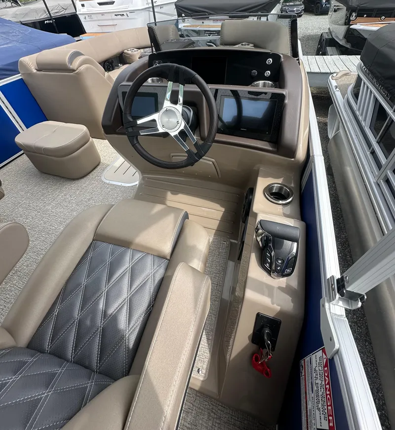 Slide: The Image of 2025 Bennington 23 LXSFB boat interior with steering wheel and control panel. - 9
