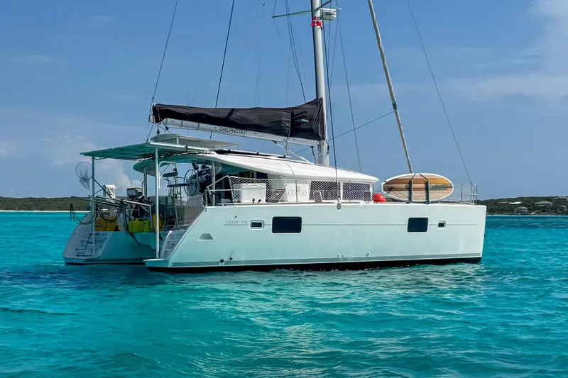 The Image of 2011 Lagoon 400 catamaran sailing on clear turquoise waters under a blue sky. - 0