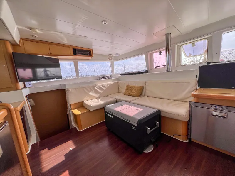 Slide: The Image of Interior of 2011 Lagoon 400 catamaran with cozy seating and modern amenities. - 13