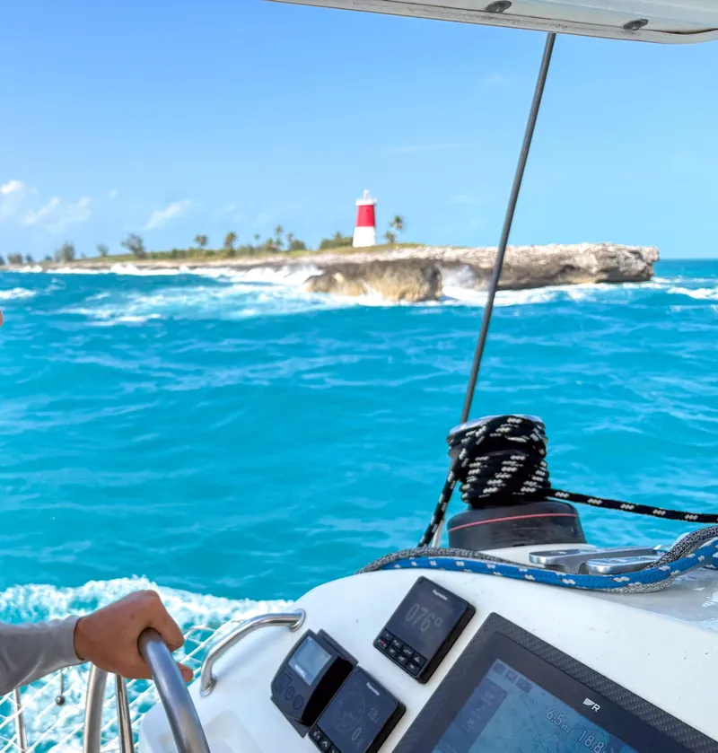 Slide: The Image of Sailing Lagoon 400 near a lighthouse on turquoise waters, 2011 model. - 18