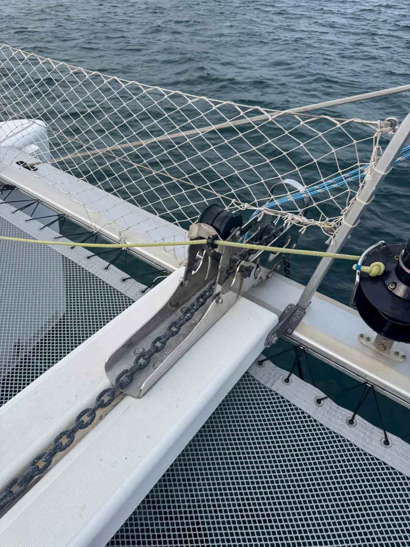 Slide: The Image of Close-up of a 2011 Lagoon 400 catamaran's anchor chain and netting on deck. - 19