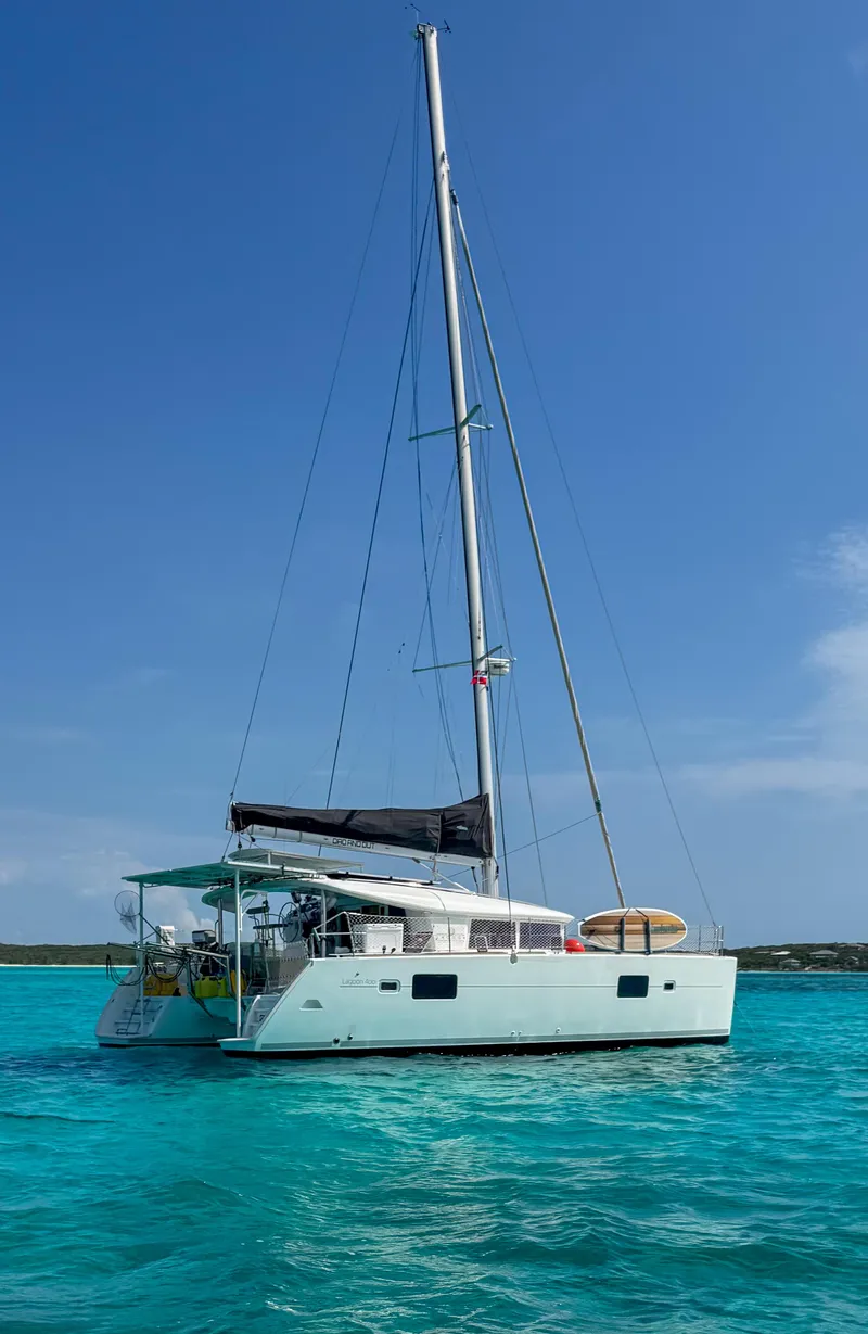 Slide: The Image of Sailing catamaran Lagoon 400, 2011 model, anchored in clear turquoise waters. - 25