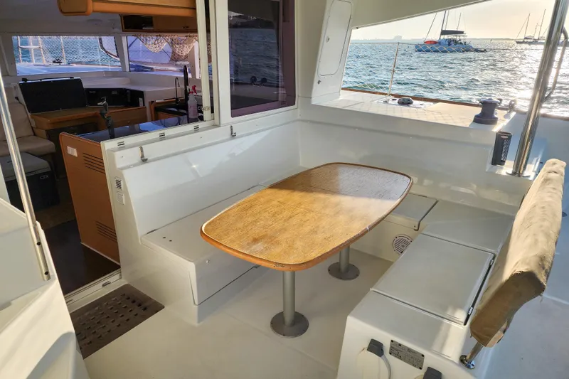 Slide: The Image of 2011 Lagoon 400 catamaran interior with dining area, ocean view, and cozy seating. - 26