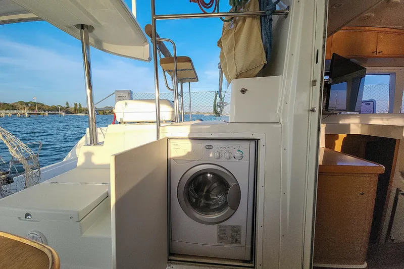 Slide: The Image of Lagoon 400 catamaran interior with washing machine, 2011 model, docked by the water. - 28