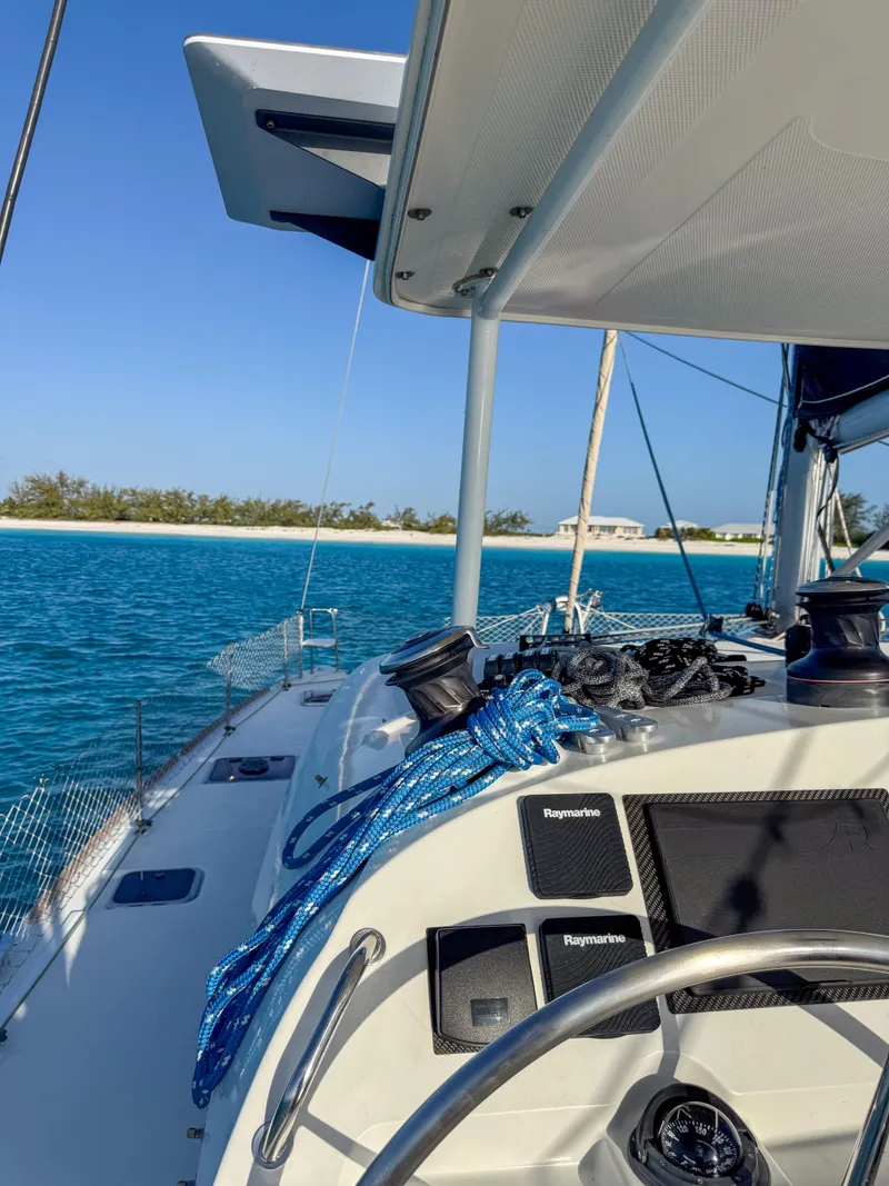 Slide: The Image of Lagoon 400 sailboat cruising near a tropical island, clear blue water, sunny day. - 3
