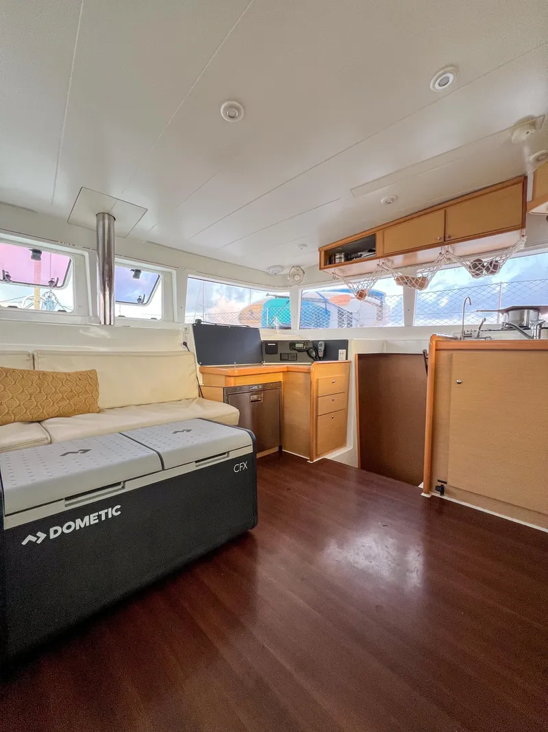 Slide: The Image of Interior of 2011 Lagoon 400 catamaran with modern furnishings and wooden flooring. - 34
