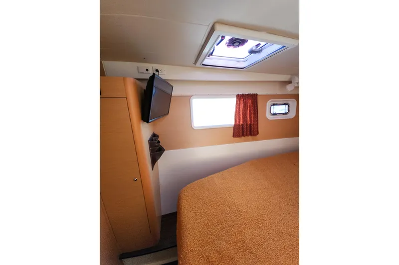Slide: The Image of Interior cabin of 2011 Lagoon 400 catamaran with bed, window, and TV. - 42