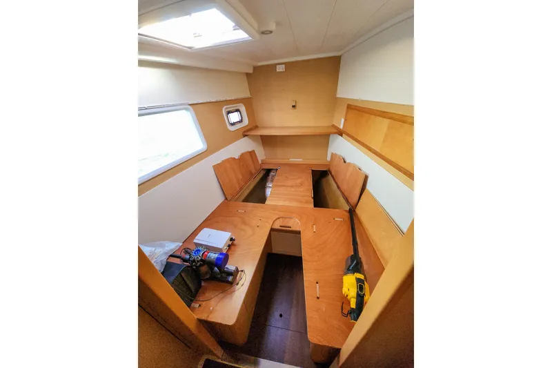 Slide: The Image of Interior of 2011 Lagoon 400 catamaran cabin with wooden furnishings and tools. - 47