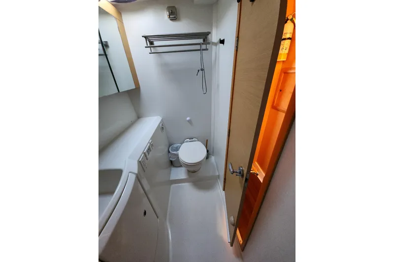 Slide: The Image of Compact bathroom in 2011 Lagoon 400 yacht with toilet, sink, and storage. - 49