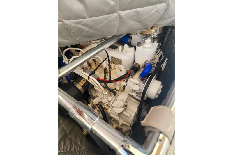 Slide: The Image of Engine compartment of a 2011 Lagoon 400 catamaran, showcasing mechanical components. - 53