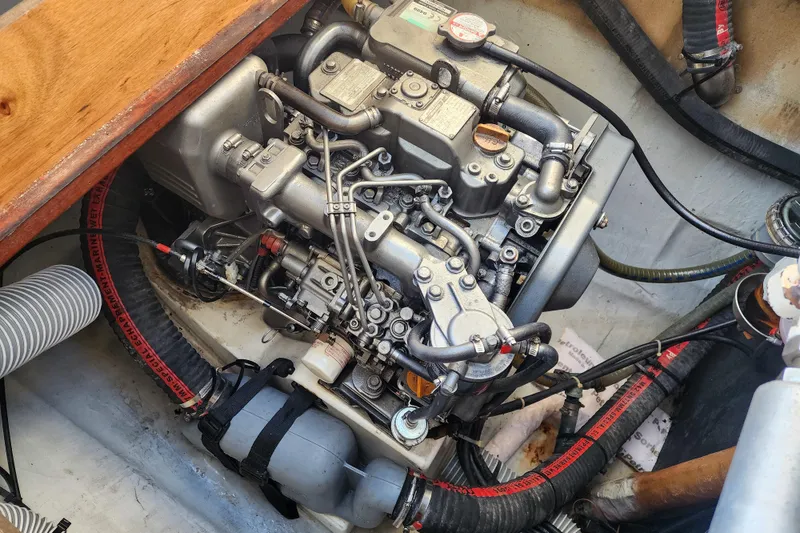 Slide: The Image of Engine compartment of a 2011 Lagoon 400 catamaran, showcasing detailed mechanical components. - 54