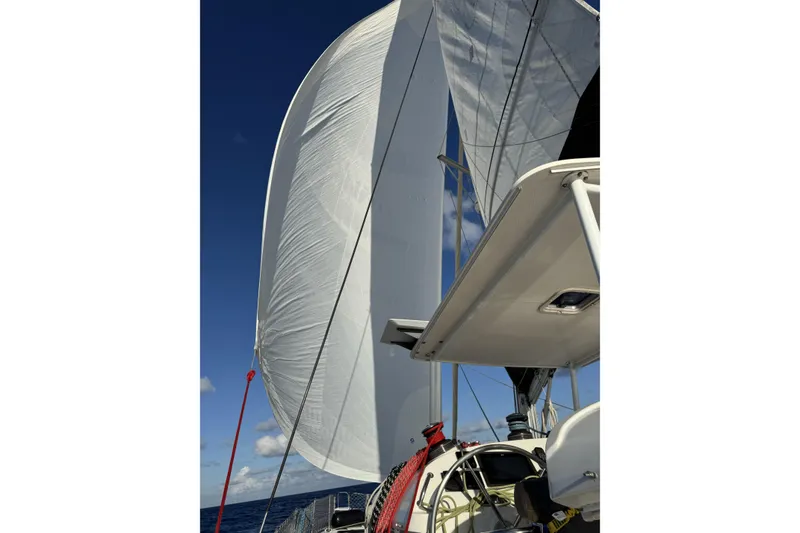 Slide: The Image of Sailing on a 2011 Lagoon 400 catamaran with full sails against a clear blue sky. - 61