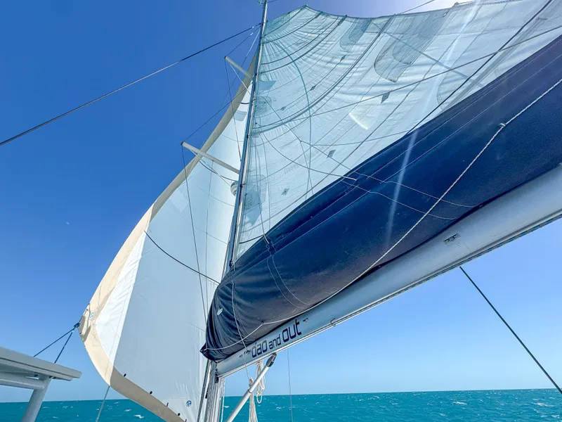 Slide: The Image of Sailing on a 2011 Lagoon 400 catamaran with full sails against a clear blue sky. - 62