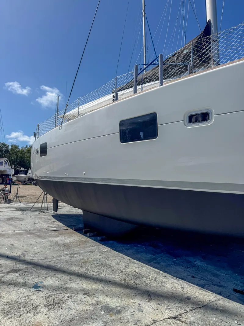 Slide: The Image of 2011 Lagoon 400 catamaran on dry dock under clear blue sky. - 66