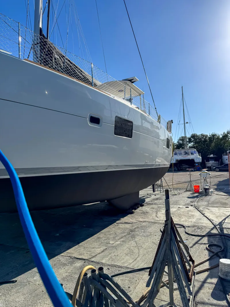 Slide: The Image of 2011 Lagoon 400 catamaran on dry dock under clear blue sky. - 67