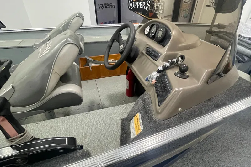 Slide: The Image of 2004 Lund 1800SS boat interior with steering console and seating. - 3