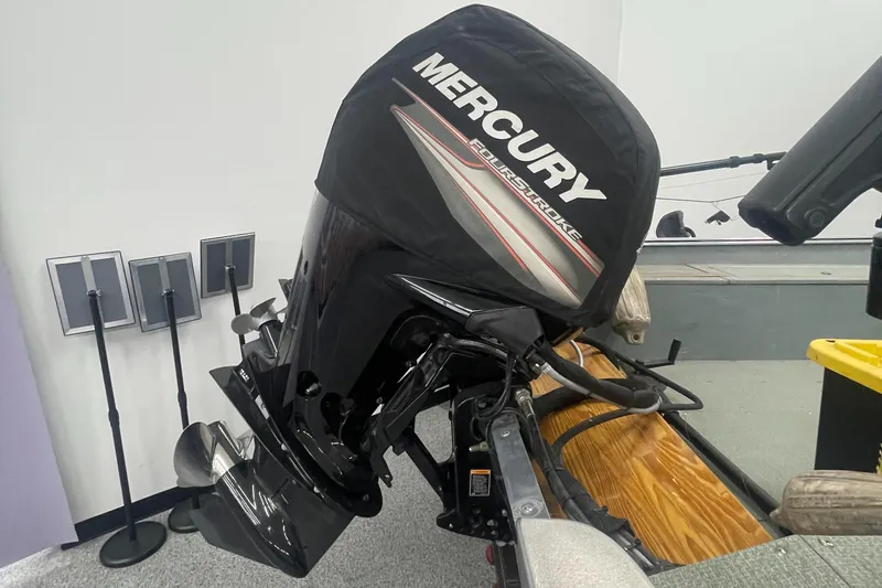 Slide: The Image of 2004 Lund 1800SS boat with Mercury FourStroke outboard motor in a showroom. - 4
