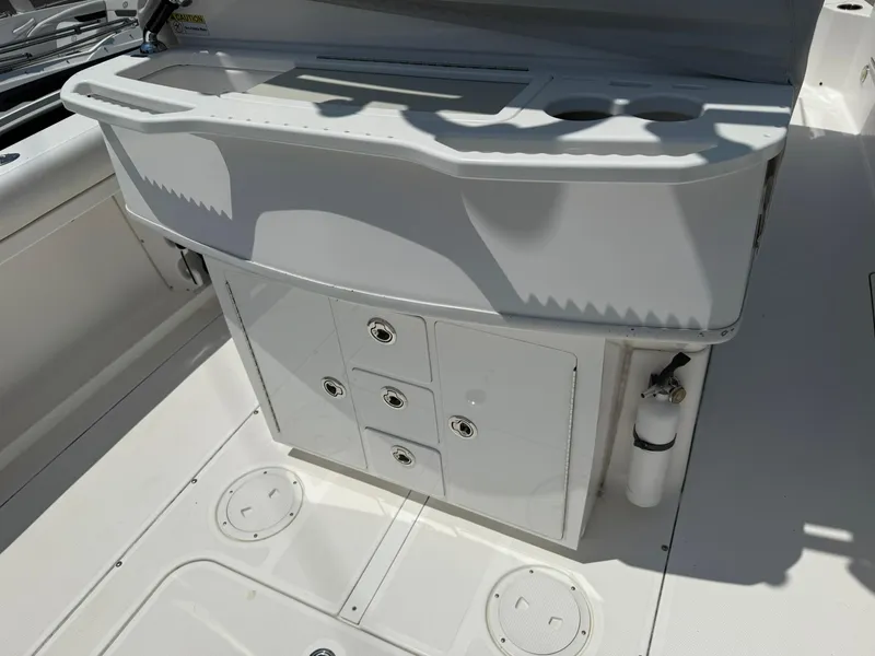 Slide: The Image of 2018 Everglades 255 Center Console boat interior with storage compartments and cup holders. - 11