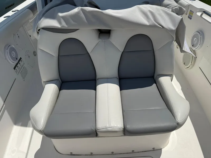 Slide: The Image of 2018 Everglades 255 Center Console boat seat with gray and white upholstery. - 12