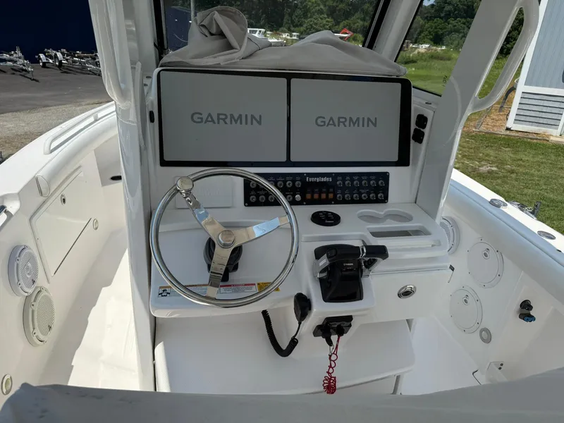 Slide: The Image of 2018 Everglades 255 Center Console boat dashboard with Garmin displays and steering wheel. - 5