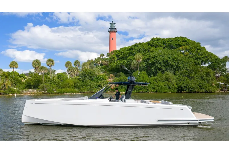 The Image of 2024 Pardo Yachts 43 cruising near a lush island with a lighthouse in the background. - 0