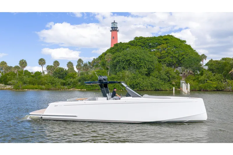 Slide: The Image of 2024 Pardo Yachts 43 cruising near a lush island with a lighthouse in the background. - 1