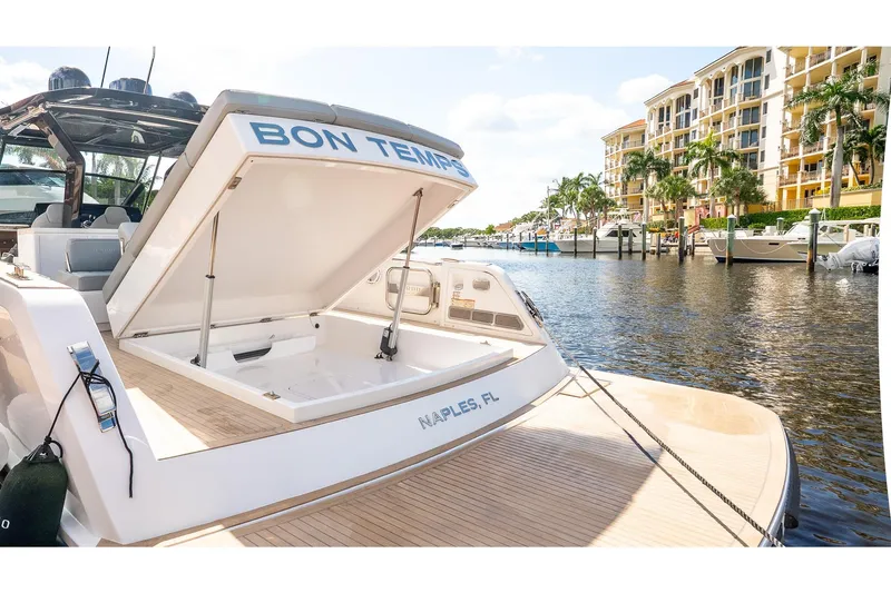 Slide: The Image of 2024 Pardo Yachts 43 docked in Naples, FL, with open storage compartment. - 10