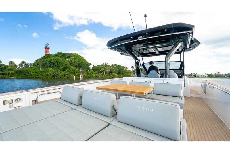 Slide: The Image of 2024 Pardo Yachts 43 cruising near a scenic lighthouse and lush greenery. - 13