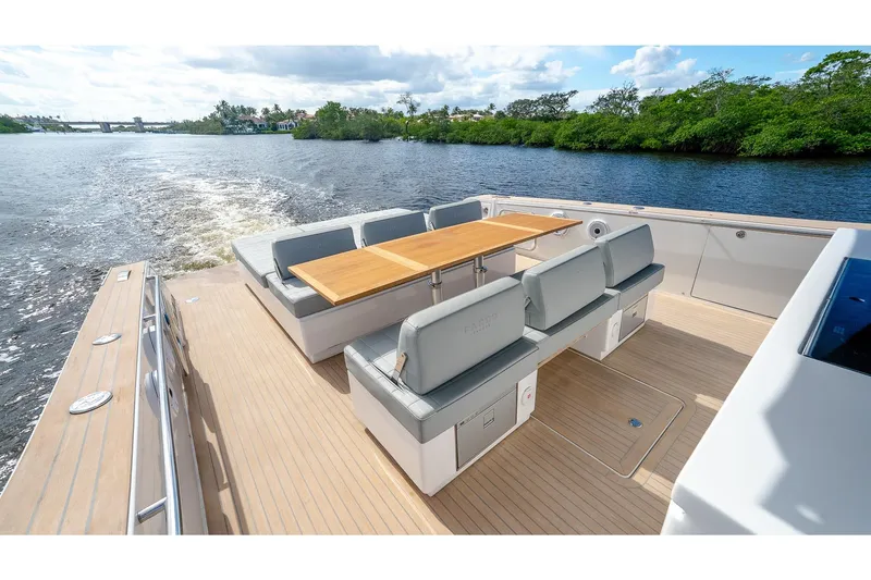 Slide: The Image of Luxurious 2024 Pardo Yachts 43 with elegant seating and table on open deck, cruising on serene waters. - 15