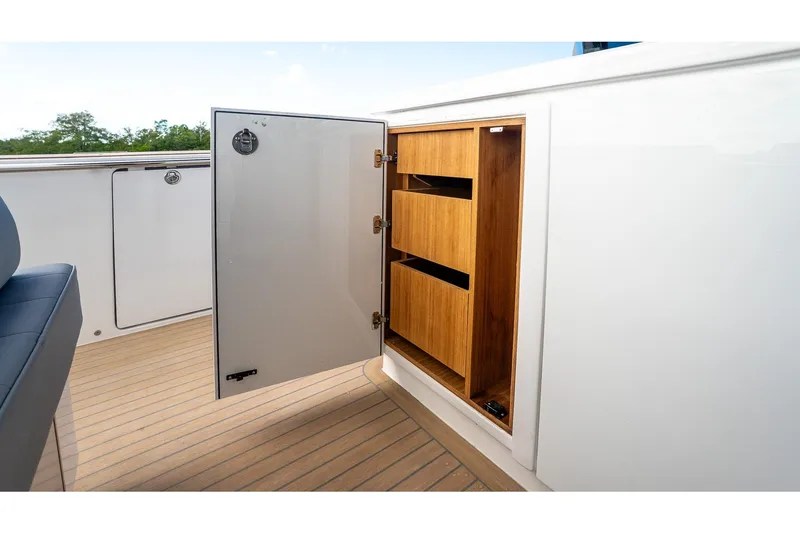 Slide: The Image of Open storage compartment on 2024 Pardo Yachts 43, featuring wooden shelves and sleek design. - 26