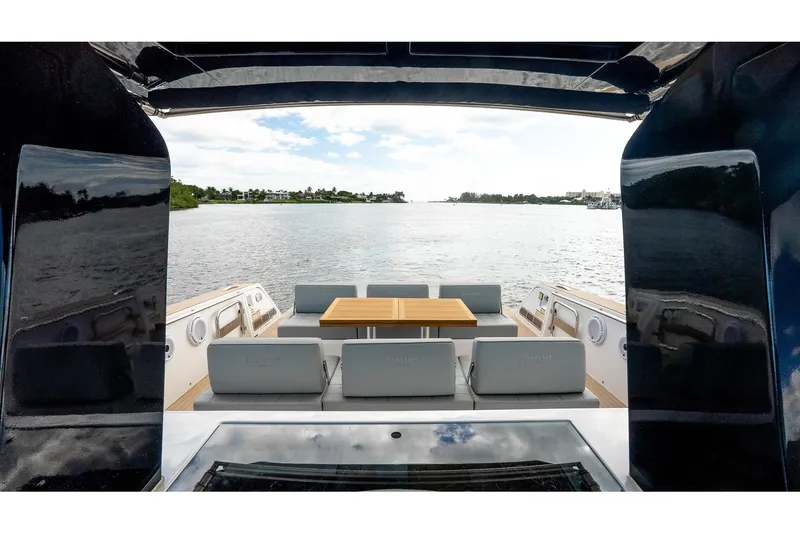 Slide: The Image of 2024 Pardo Yachts 43, elegant deck view with seating and table, overlooking serene waters. - 30