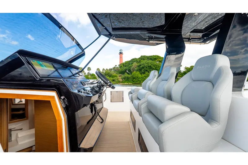 Slide: The Image of 2024 Pardo Yachts 43 interior with sleek helm and luxurious seating, lighthouse view. - 32