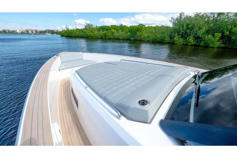 Slide: The Image of 2024 Pardo Yachts 43 with luxurious deck seating on a serene waterway. - 40