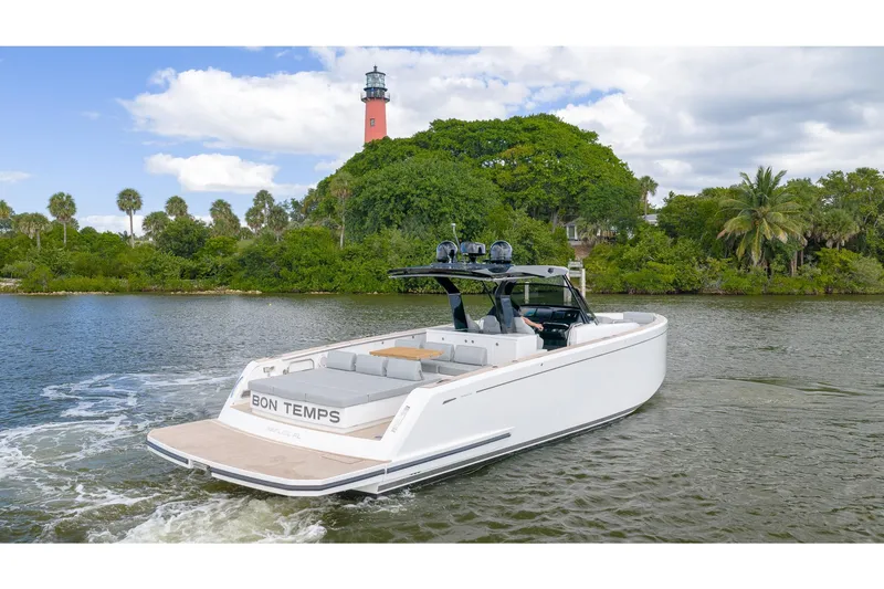 Slide: The Image of 2024 Pardo Yachts 43 cruising near a lush island with a lighthouse. - 6