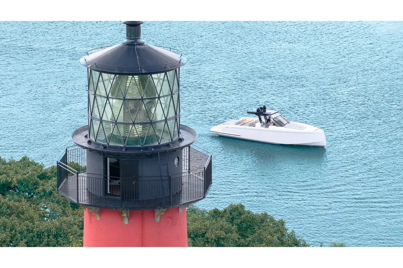 Slide: The Image of 2024 Pardo Yachts 43 near a lighthouse on calm blue water. - 7