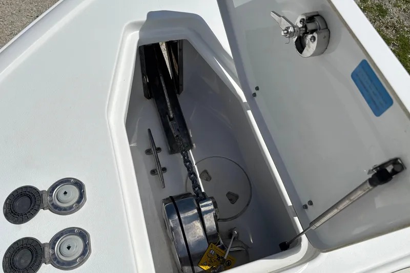 Slide: The Image of Anchor compartment of 2021 Sea Hunt Ultra 265 SE boat, featuring storage and hardware. - 10