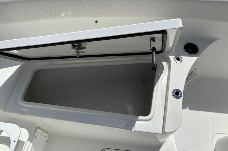 Slide: The Image of Open storage compartment on 2021 Sea Hunt Ultra 265 SE boat. - 11