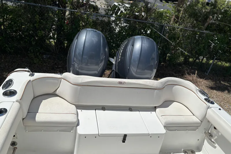 Slide: The Image of 2021 Sea Hunt Ultra 265 SE boat interior with seating and cup holders. - 17