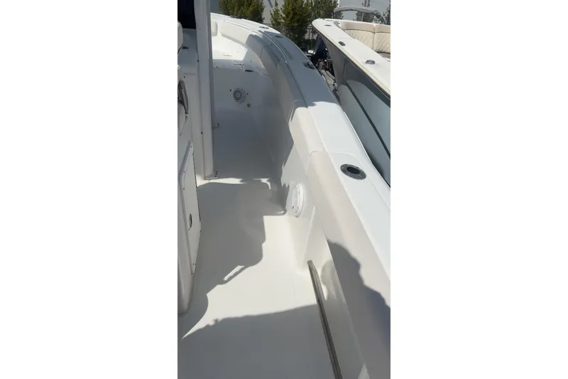 Slide: The Image of 2021 Sea Hunt Ultra 265 SE boat interior, featuring sleek white deck design. - 20