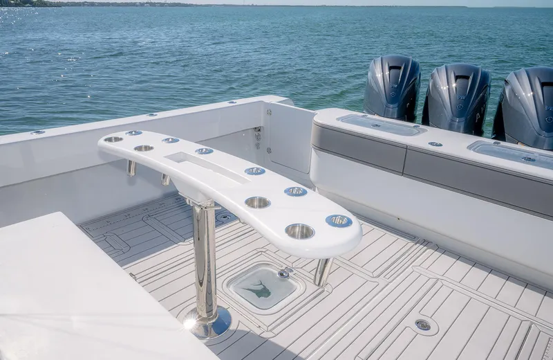 Slide: The Image of Contender 44ST 2020 boat deck with rod holders and triple outboard engines. - 11