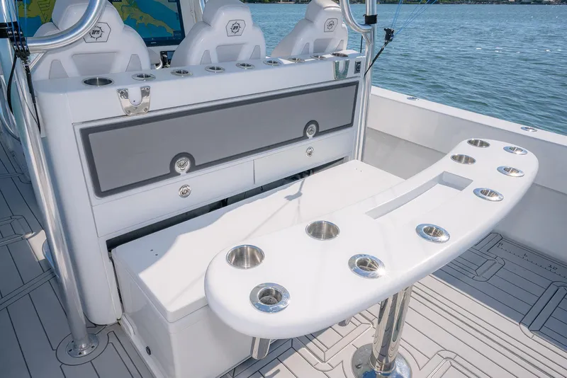 Slide: The Image of Contender 44ST 2020 boat interior with rod holders and seating, on a sunny day. - 12