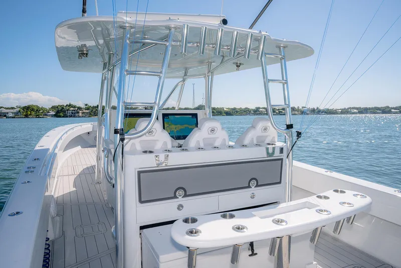 Slide: The Image of 2020 Contender 44ST boat with step hull, featuring a sleek console and seating on calm waters. - 13