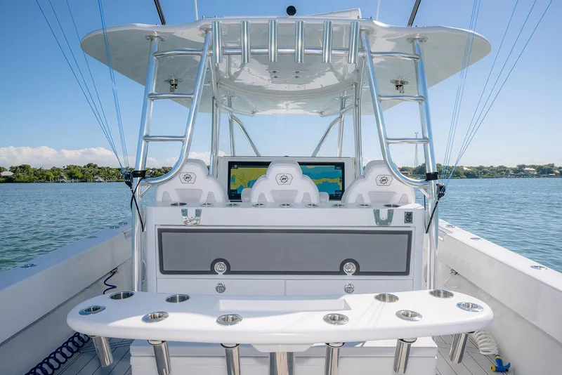 Slide: The Image of 2020 Contender 44ST boat with step hull, featuring a modern helm and fishing rod holders. - 14